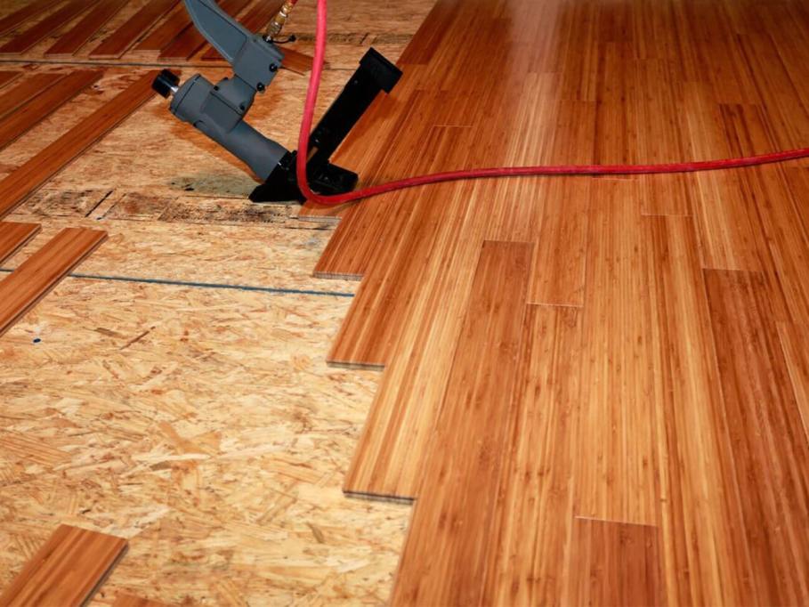 Daka Construction Worker Installing New Oak Wood Flooring In Home During Flooring Installation Project